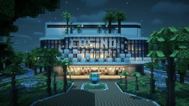 Le casino de Montello City illuminé à la nuit tombée, sa fontaine et ses palmiers éclairés